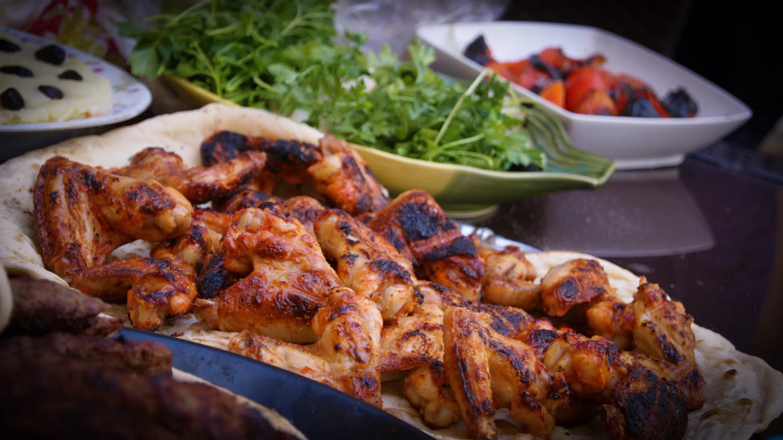 Spiced and char-grilled chicken wings on pita bread.