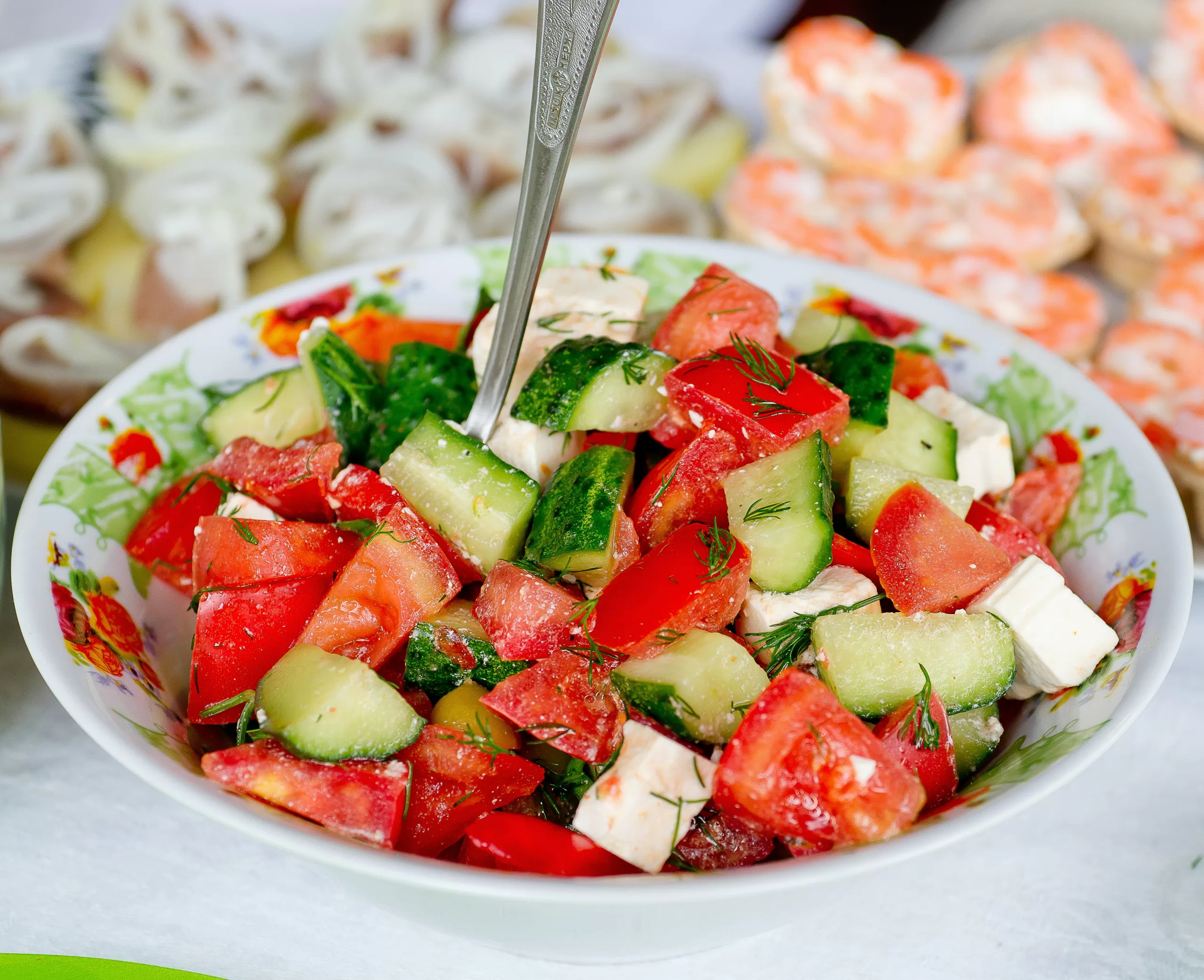 A feta, cucumber, dill and tomato summer salad bowl.